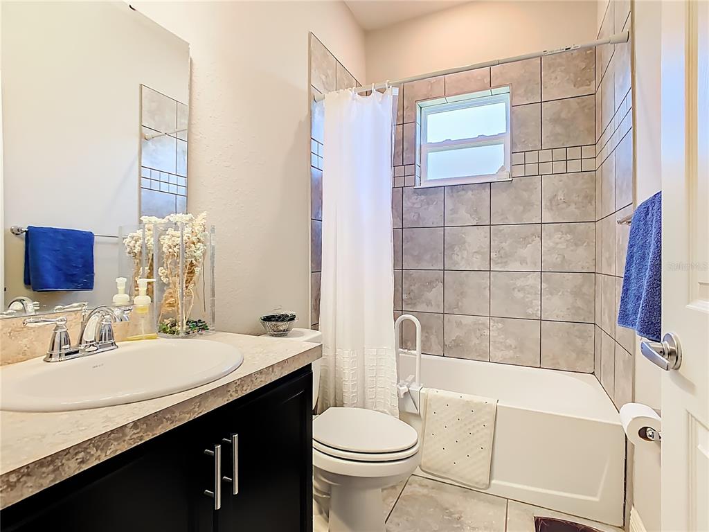 237 Walkers Point Drive Auburndale, FL 33823 - Photo 21 of 31 a bathroom with a sink a toilet a mirror and shower