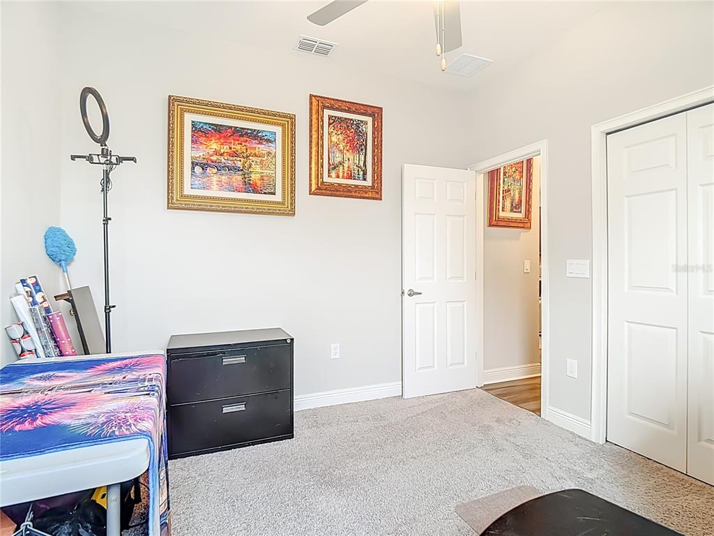 237 Walkers Point Drive Auburndale, FL 33823 - Photo 22 of 31 a bedroom with a bed and a table