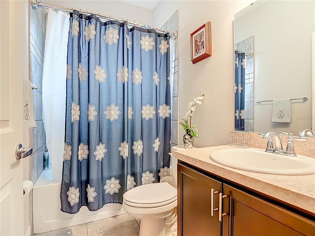 237 Walkers Point Drive Auburndale, FL 33823 - Photo 23 of 31 a bathroom with a granite countertop sink and a toilet