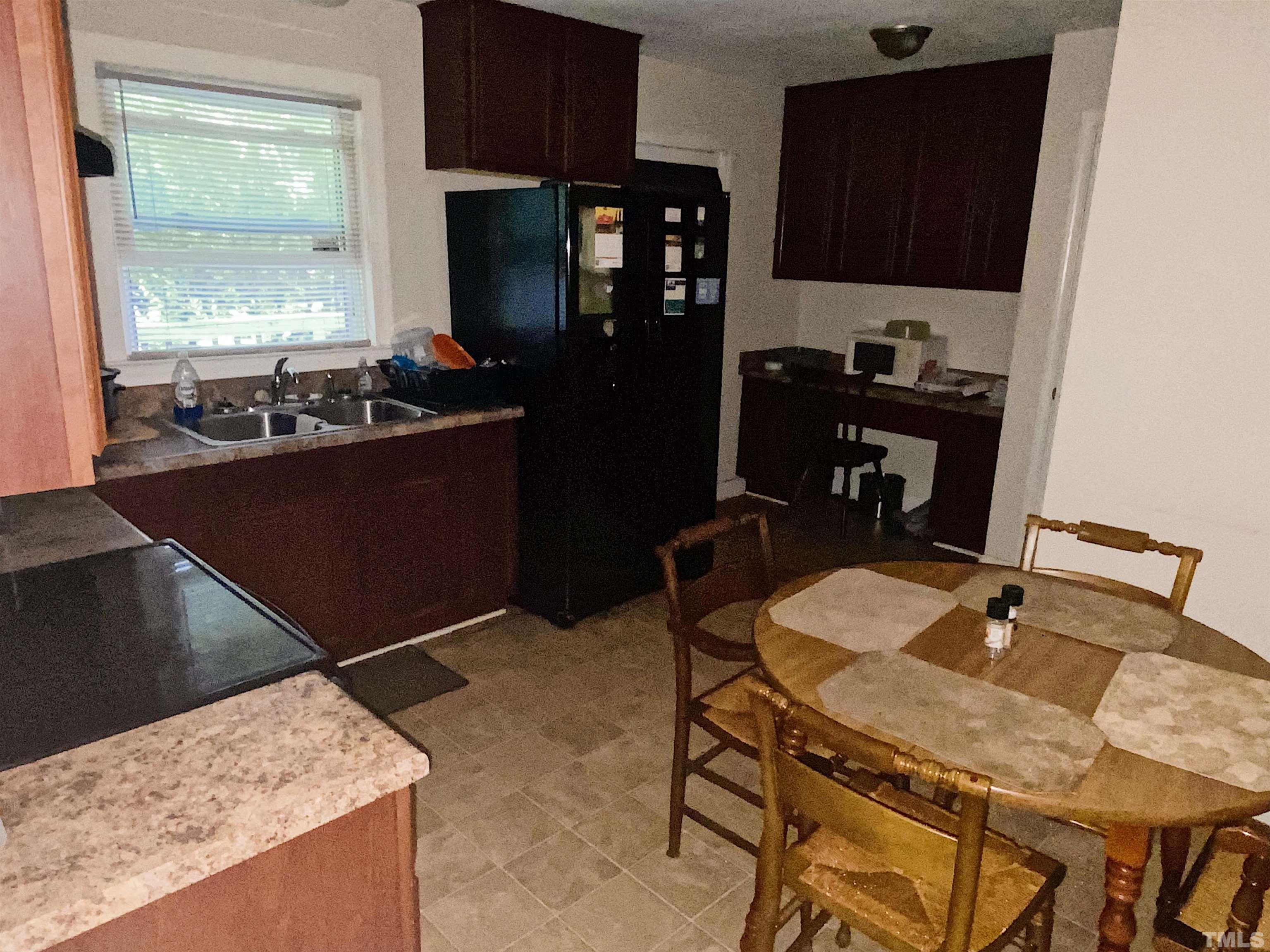 610 St George Road Raleigh, NC 27610 - Photo 4 of 9 a kitchen with a refrigerator and a stove top oven