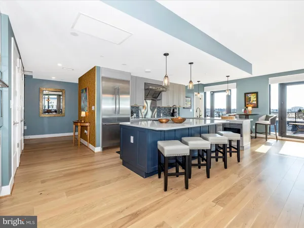 a living room with stainless steel appliances kitchen island granite countertop furniture and a kitchen view