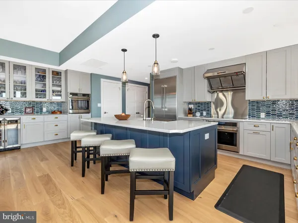 a kitchen with granite countertop a sink cabinets and wooden floor