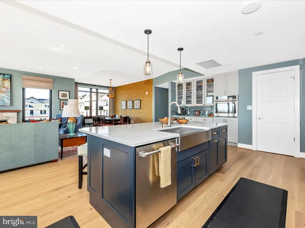 a kitchen with granite countertop a sink cabinets and wooden floor