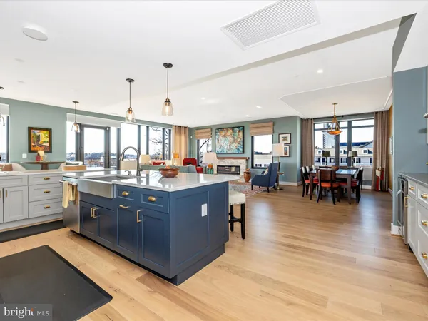 a kitchen view with stainless steel appliances granite countertop a stove and a wooden floors