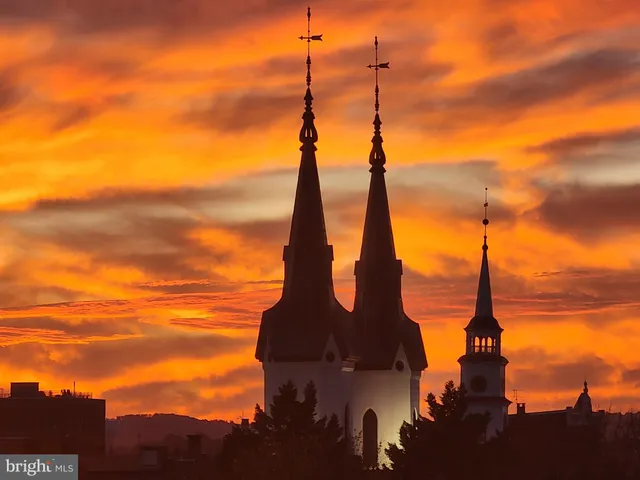 a bathroom with a sink a vanity and painting on the wall