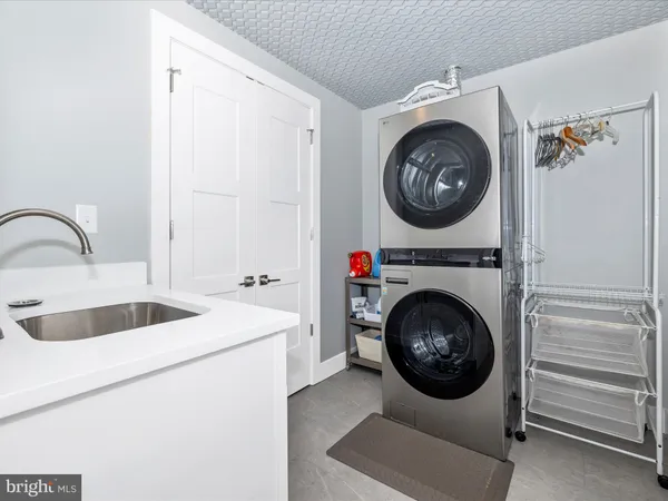 a utility room with sink dryer and washer
