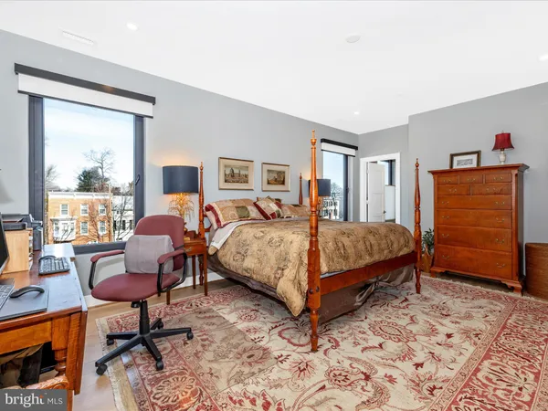 a bedroom with a bed chair and window