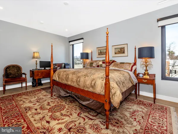 a bedroom with a bed a lamp and a dresser