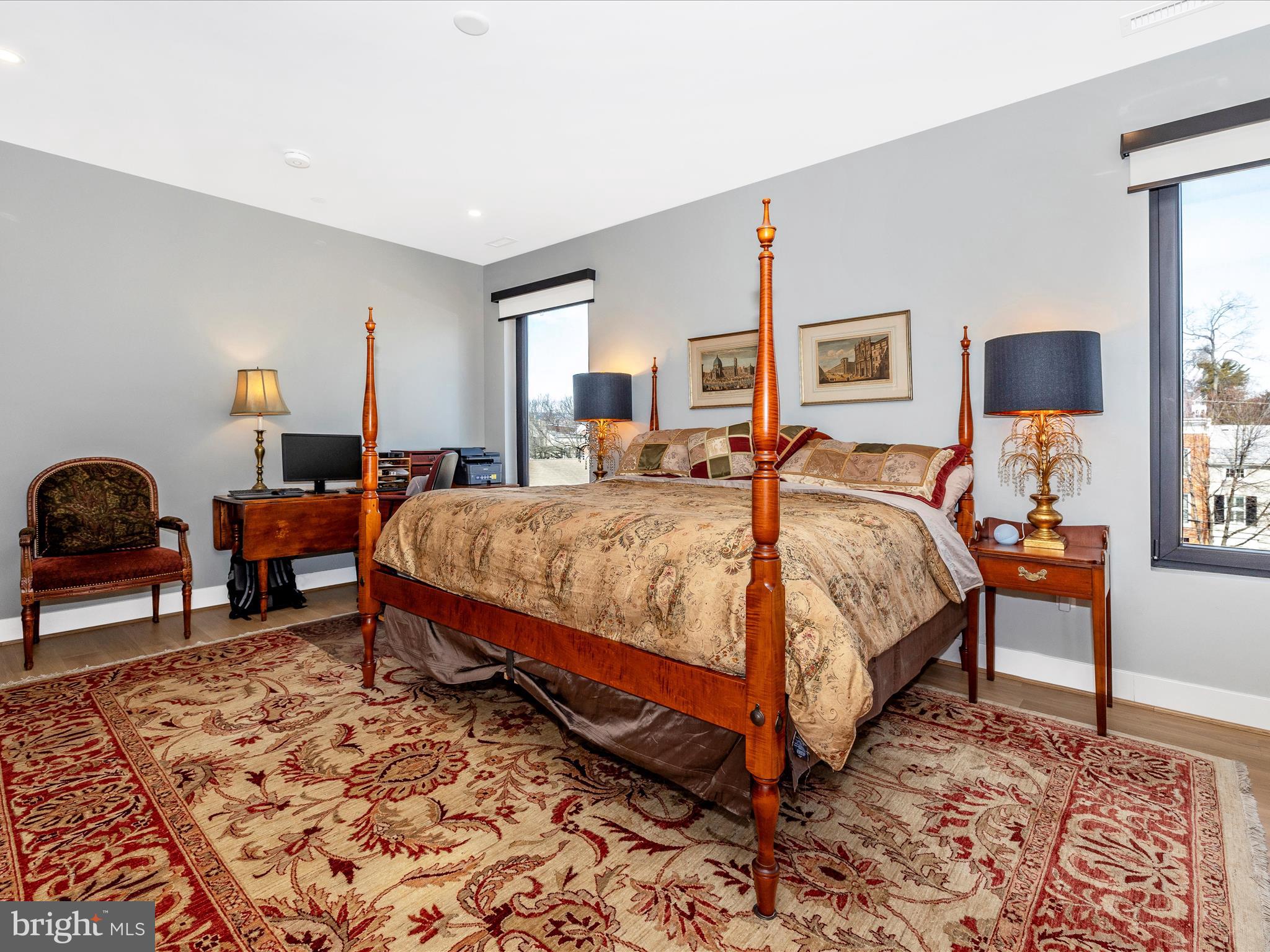 210 East 2nd Street, Unit 401 Frederick, MD 21701 - Photo 38 of 51 a bedroom with a bed a lamp and a dresser