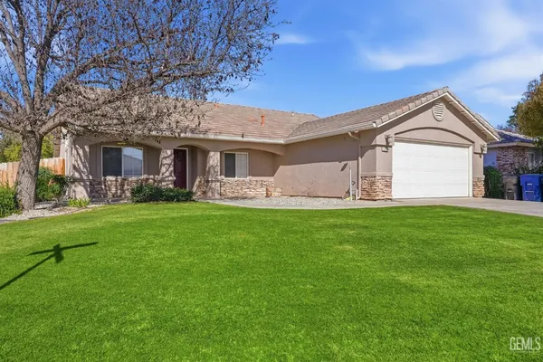 a front view of house with yard and green space