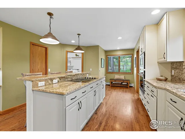 a kitchen with sink stove and refrigerator
