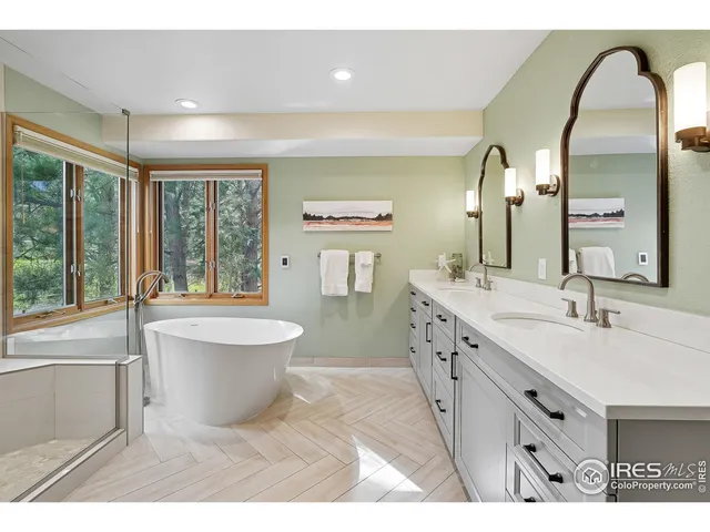 a spacious bathroom with a double vanity sink a mirror and a bathtub