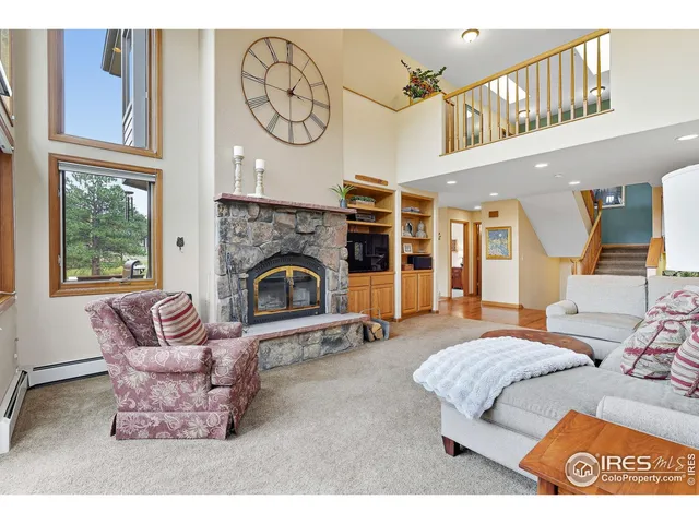 a living room with furniture a fireplace and a window