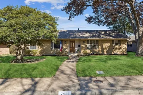 a view of a table and chairs in the garden