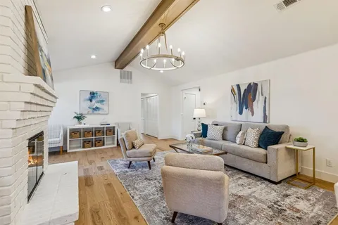 a living room with furniture wooden floor and a fireplace