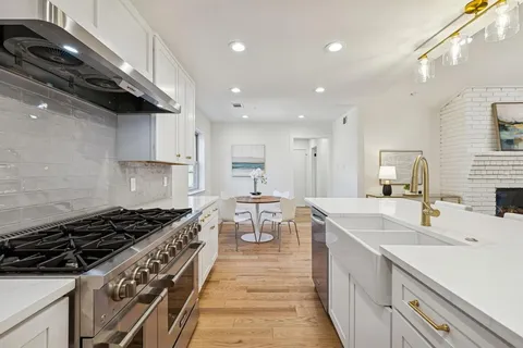 a kitchen with a sink stove and cabinets