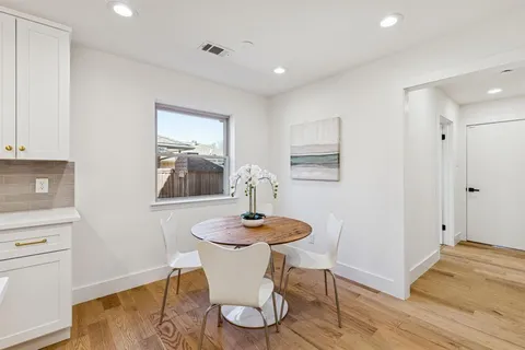 a dining room with furniture and wooden floor