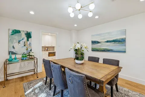 a dining room with furniture and chandelier