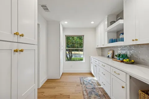 a kitchen with stainless steel appliances granite countertop a refrigerator and a stove