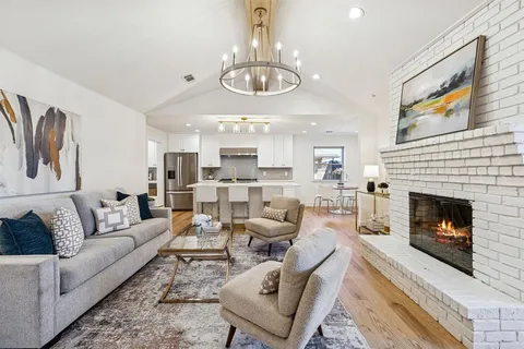 a living room with furniture kitchen and a fireplace