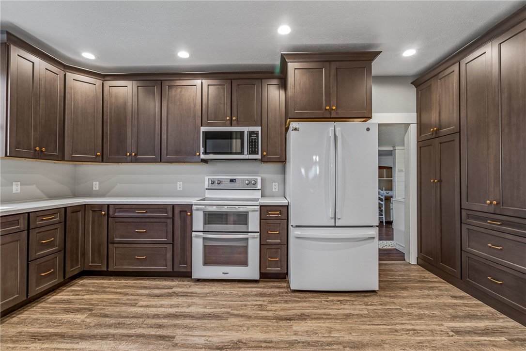 8700 Quaker Trace Road Camden, OH 45311 - Photo 7 of 34 This contemporary kitchen features elegant cabinetry and modern appliances, perfect for culinary enthusiasts.