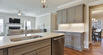 3409 Sincerity Road, Unit 15 Monroe, NC 28110 - Photo 13 of 32 a kitchen with a sink and a refrigerator