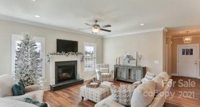 3409 Sincerity Road, Unit 15 Monroe, NC 28110 - Photo 15 of 32 a living room with furniture a flat screen tv and a fireplace