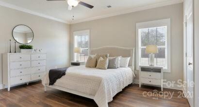 3409 Sincerity Road, Unit 15 Monroe, NC 28110 - Photo 22 of 32 a bedroom with a bed and a mirror
