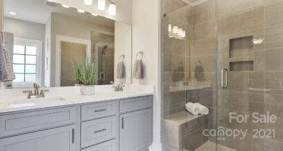 3409 Sincerity Road, Unit 15 Monroe, NC 28110 - Photo 24 of 32 a bathroom with a shower sink and mirror