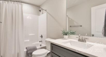 3409 Sincerity Road, Unit 15 Monroe, NC 28110 - Photo 27 of 32 a bathroom with a granite countertop sink toilet and shower