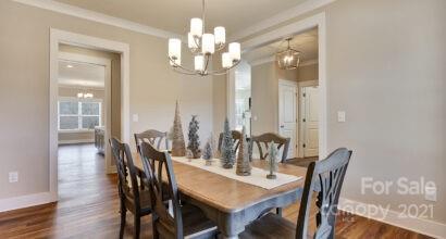 3409 Sincerity Road, Unit 15 Monroe, NC 28110 - Photo 3 of 32 a view of a dining room with furniture wooden floor and chandelier