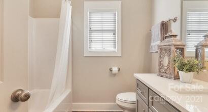 3409 Sincerity Road, Unit 15 Monroe, NC 28110 - Photo 5 of 32 a bathroom with a granite countertop sink toilet and mirror