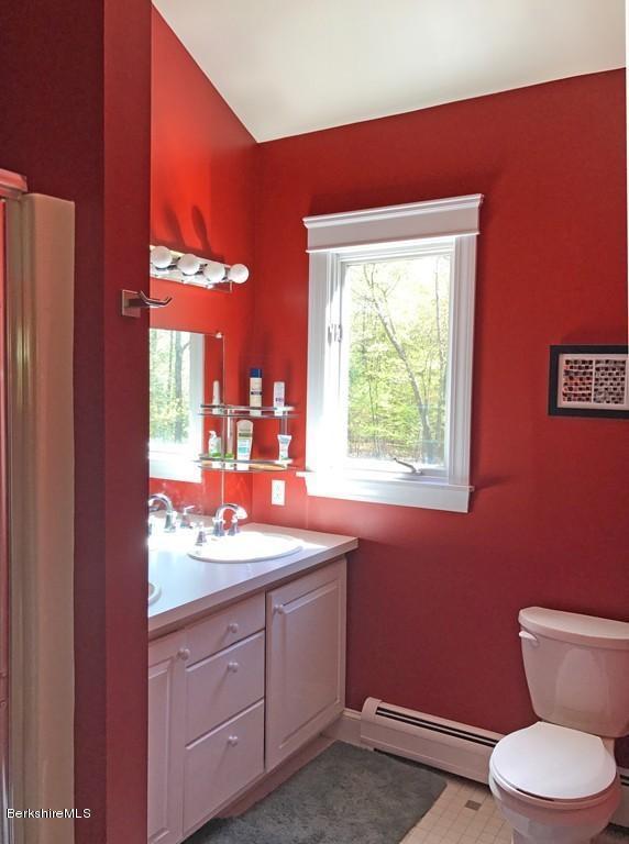 7 Cider Mill Road Williamsburg, MA 01039 - Photo 13 of 30 a bathroom with a toilet sink and mirror
