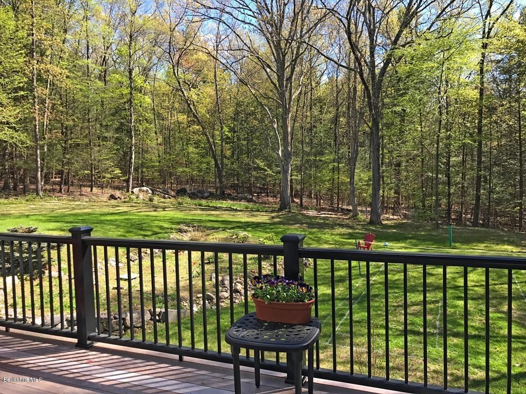 7 Cider Mill Road Williamsburg, MA 01039 - Photo 29 of 30 a front view of a house with a yard table and chairs
