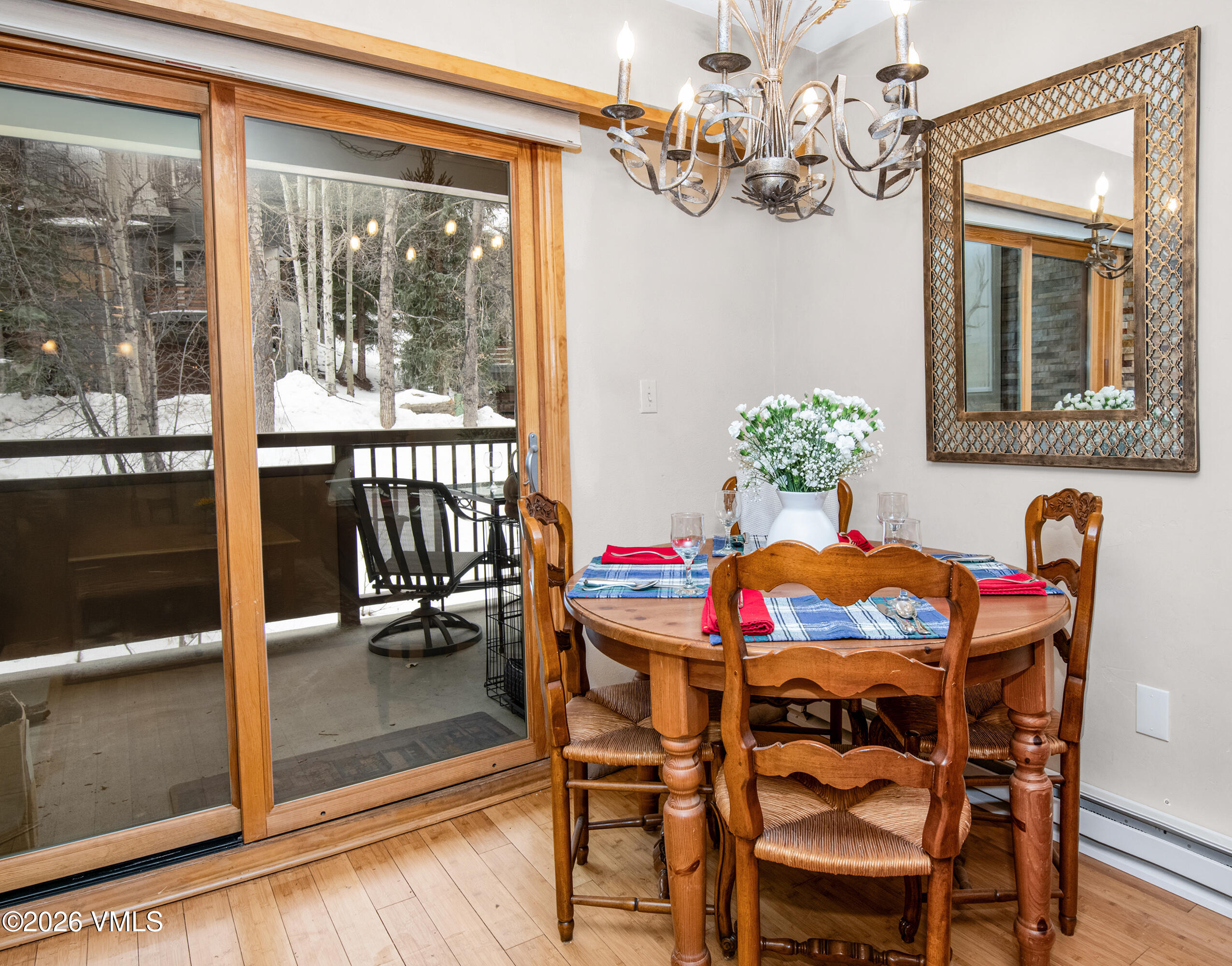1650 Fall Ridge Road, Unit 202 Vail, CO 81657 - Photo 7 of 32 a dining room with furniture a chandelier and wooden floor