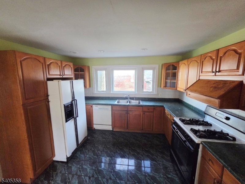 377 Lum Avenue Union, NJ 07083 - Photo 5 of 13 a kitchen with stainless steel appliances granite countertop a refrigerator a sink and a stove