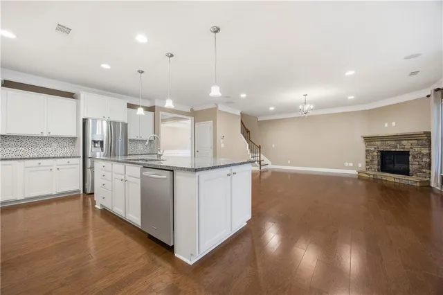 a kitchen with stainless steel appliances granite countertop a stove and a refrigerator