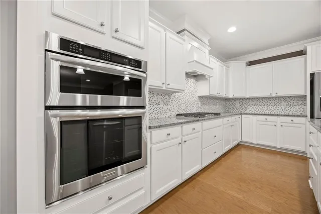 a kitchen with granite countertop cabinets and oven