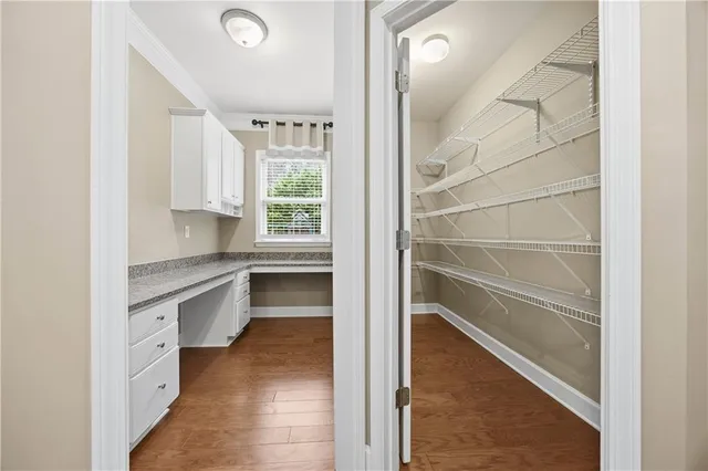 a kitchen with white cabinets and a sink