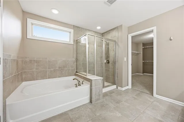 a bathroom with a bathtub and a shower