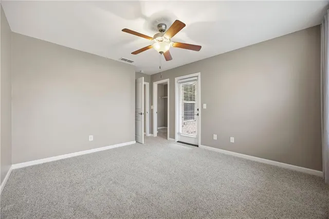 a view of an empty room with a ceiling fan