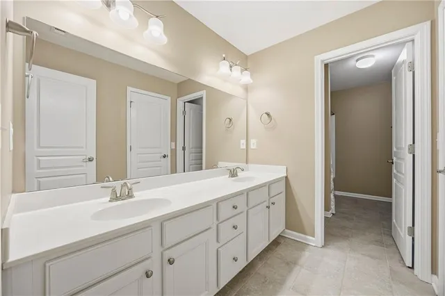 a spacious bathroom with a double vanity sink mirror and double