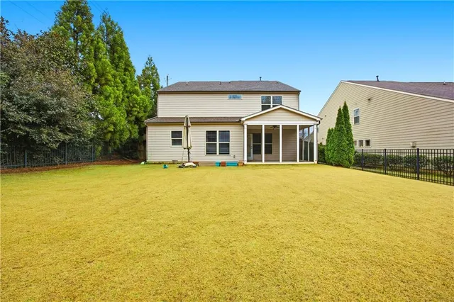 a house view with swimming pool in front of it