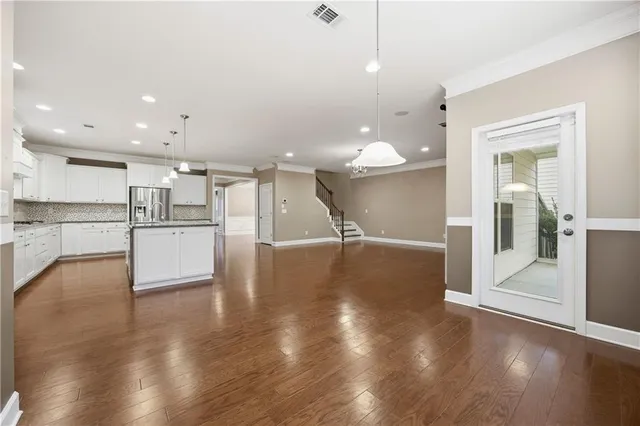 a view of kitchen with cabinets and wooden floor