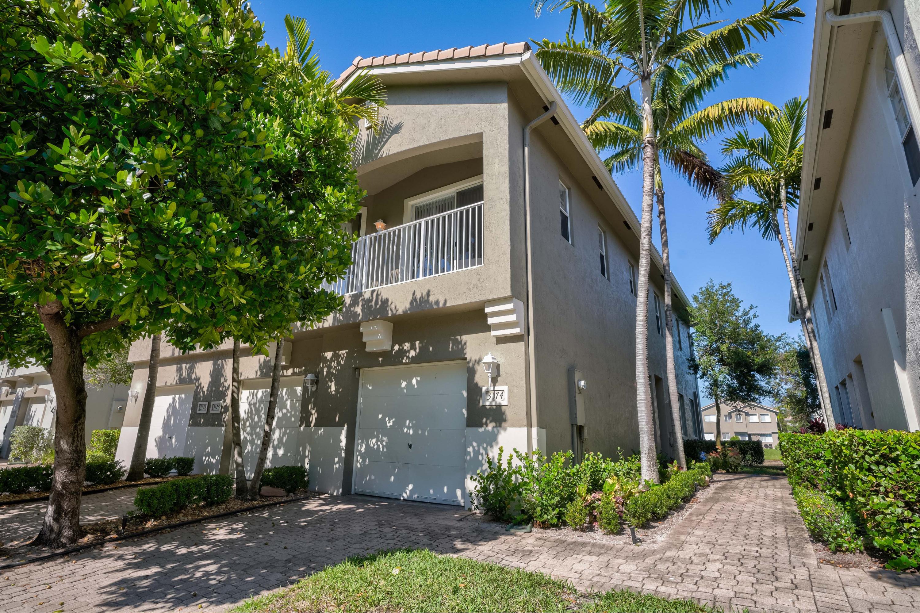 3174 Laurel Ridge Circle Riviera Beach, FL 33404 - Photo 31 of 32 a front view of a house with a yard