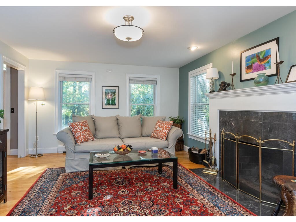 79 Pomeroy Meadow Road Southampton, MA 01073 - Photo 11 of 42 a living room with furniture a fireplace and a window
