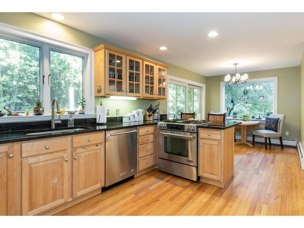 79 Pomeroy Meadow Road Southampton, MA 01073 - Photo 15 of 42 a kitchen with stainless steel appliances granite countertop a stove a sink and a microwave