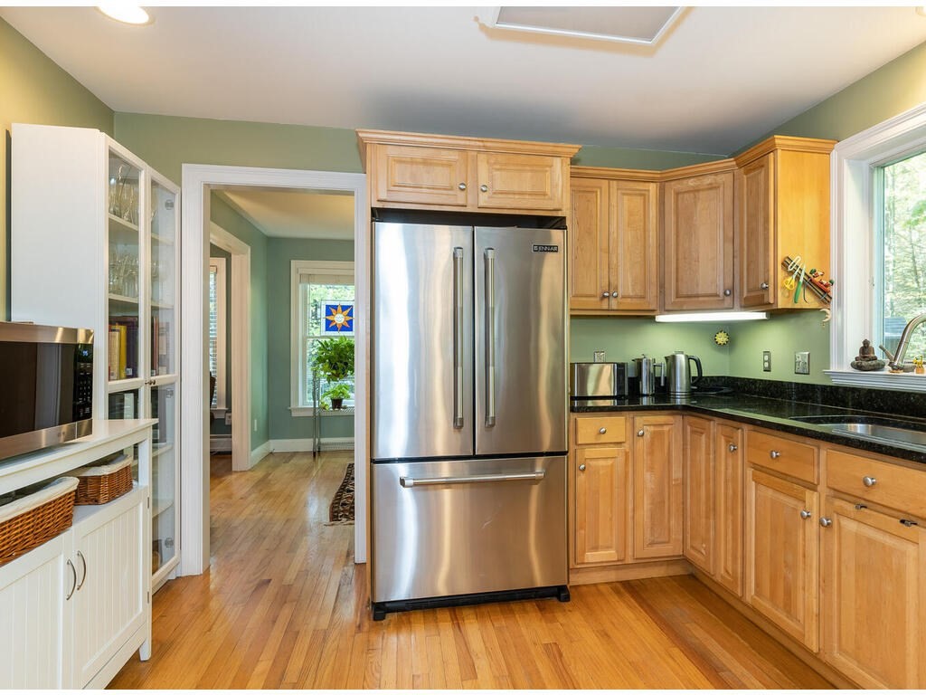 79 Pomeroy Meadow Road Southampton, MA 01073 - Photo 19 of 42 a kitchen with granite countertop wooden floors stainless steel appliances a sink and a window