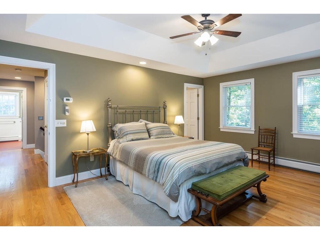 79 Pomeroy Meadow Road Southampton, MA 01073 - Photo 26 of 42 a bedroom with a bed and a chandelier