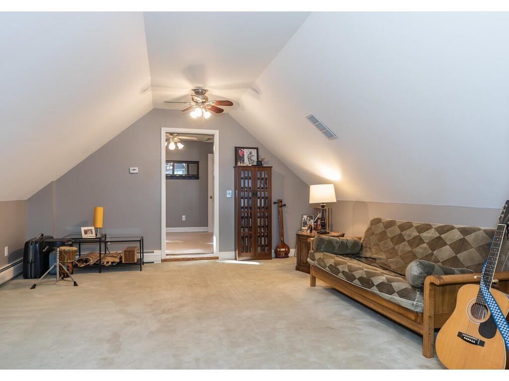 79 Pomeroy Meadow Road Southampton, MA 01073 - Photo 40 of 42 a living room with furniture ceiling fan and a rug
